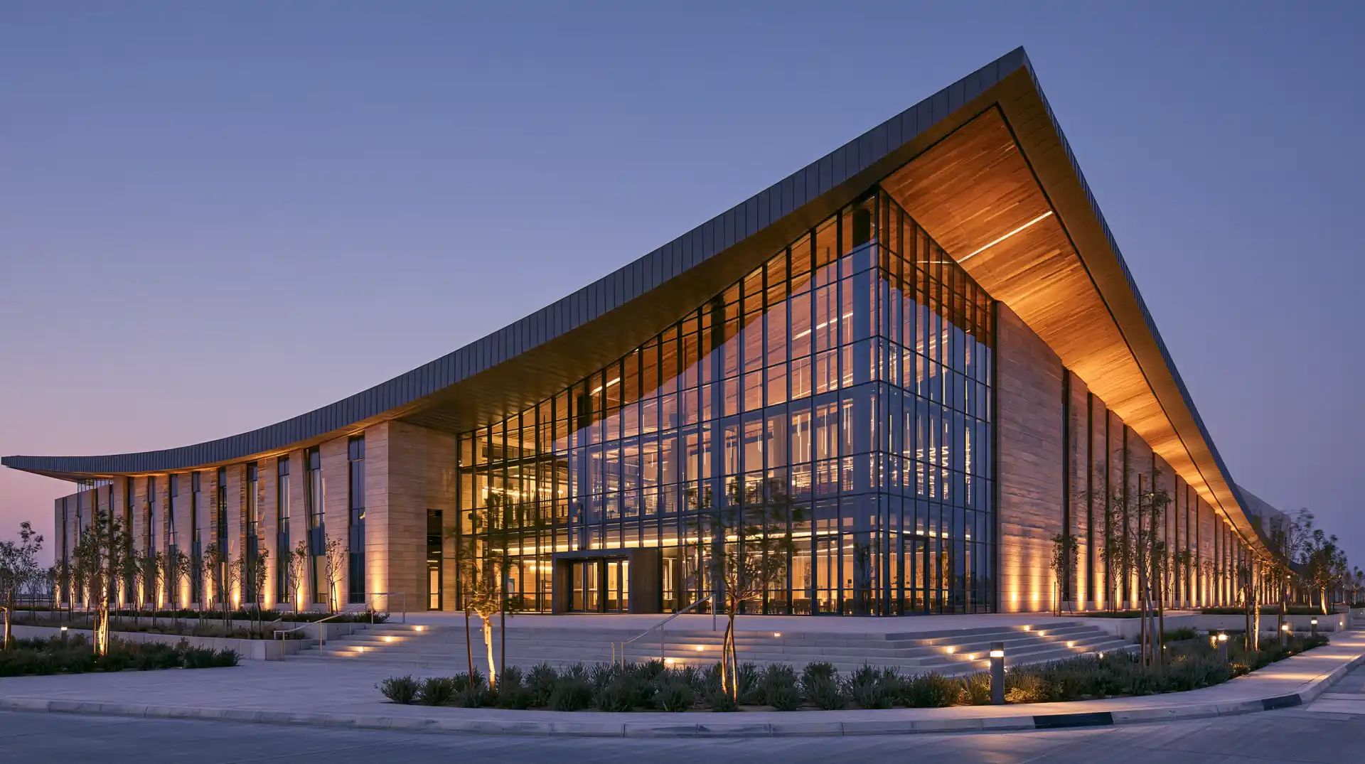 A modern school campus building at dusk